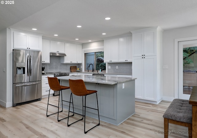 10262 SE 99th Dr, Happy Valley, OR 97086 - kitchen with stainless steel fridge with ice dispenser, plenty of natural light, light wood-style floors, recessed lighting, and a textured ceiling