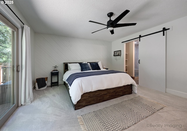 10262 SE 99th Dr, Happy Valley, OR 97086 - bedroom with a barn door, carpet, access to exterior, a textured ceiling, and ceiling fan