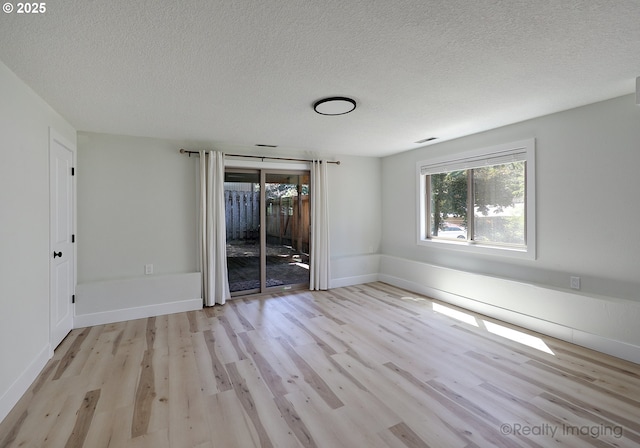 10262 SE 99th Dr, Happy Valley, OR 97086 - empty room with wood finished floors, a textured ceiling, and baseboards