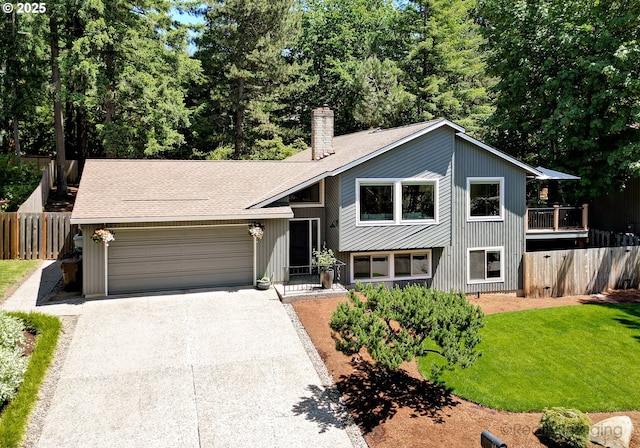 10262 SE 99th Dr, Happy Valley, OR 97086 - view of front of house featuring an attached garage, driveway, a chimney, and roof with shingles