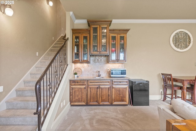 4640 SE Honors Dr, Gresham, OR 97080 - indoor wet bar with stairs, light colored carpet, ornamental molding, decorative backsplash, and stainless steel microwave