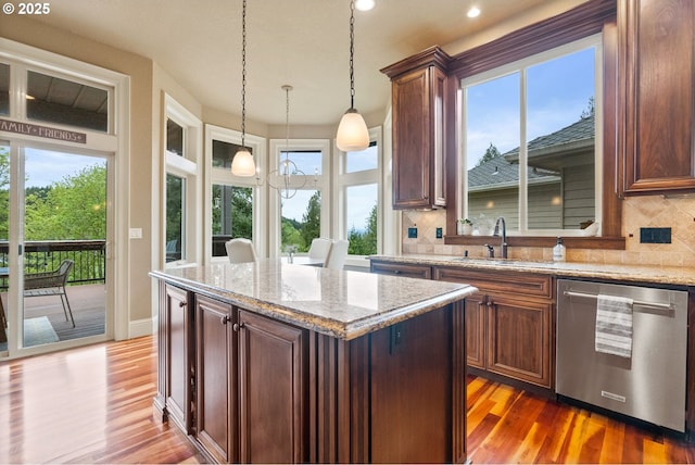 4640 SE Honors Dr, Gresham, OR 97080 - kitchen featuring stainless steel dishwasher, a sink, backsplash, wood finished floors, and recessed lighting