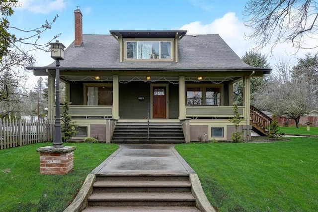 view of front of home with a front yard and covered porch