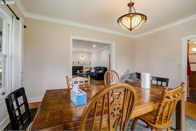 dining space featuring crown molding and hardwood / wood-style floors