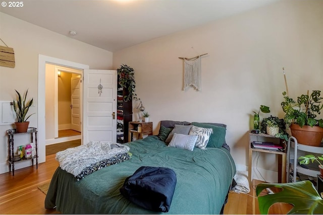 bedroom with wood-type flooring