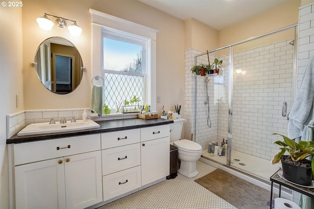 bathroom featuring vanity, toilet, and walk in shower