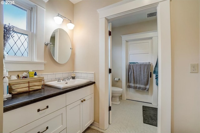 bathroom with vanity and toilet