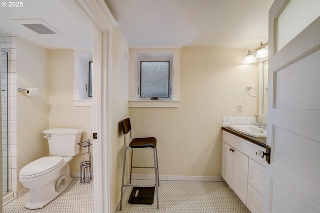 bathroom featuring vanity, tile patterned floors, and toilet