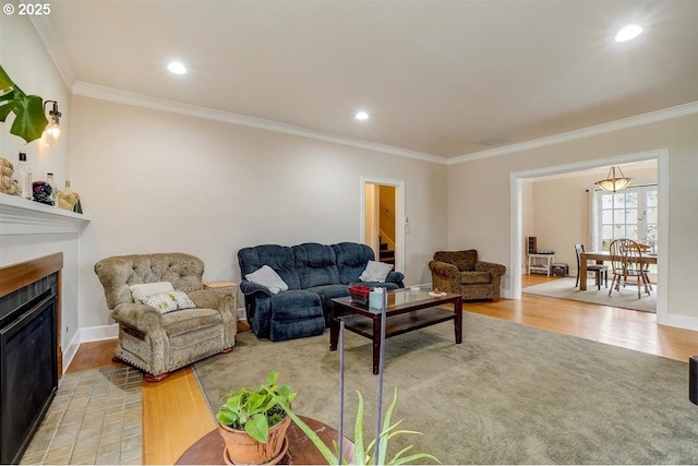 living room with crown molding and light hardwood / wood-style flooring