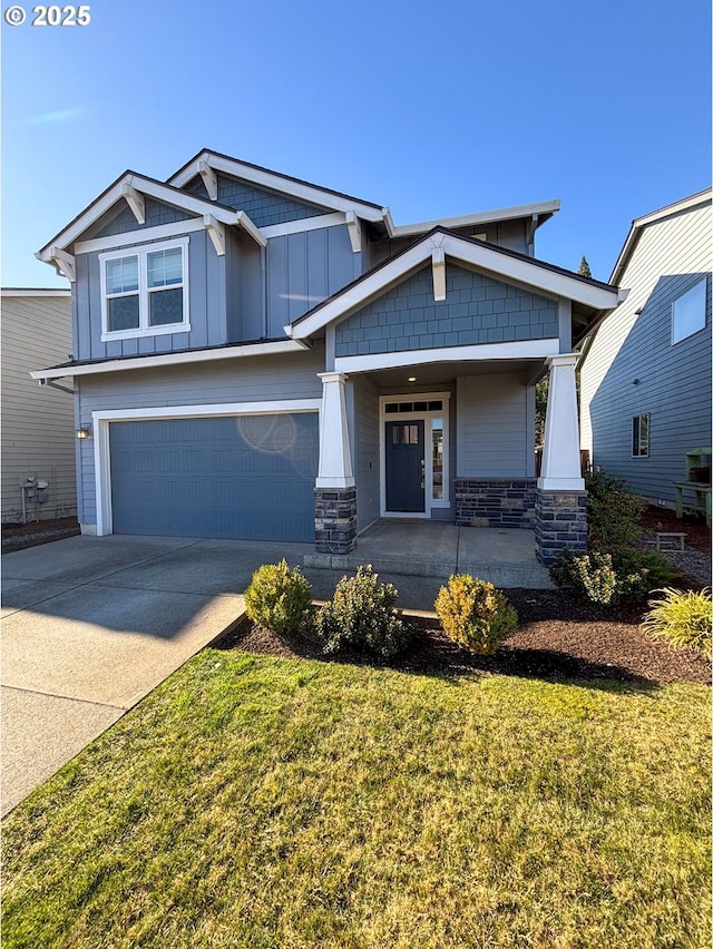 craftsman-style house featuring a garage, a porch, and a front lawn