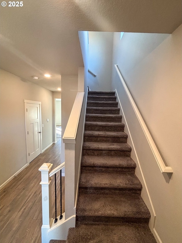 stairway with hardwood / wood-style floors