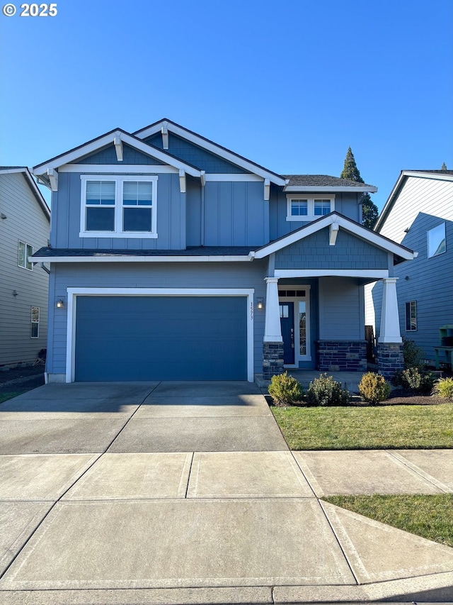 craftsman inspired home featuring a garage and covered porch