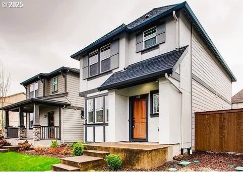 exterior space with a porch, roof with shingles, and fence