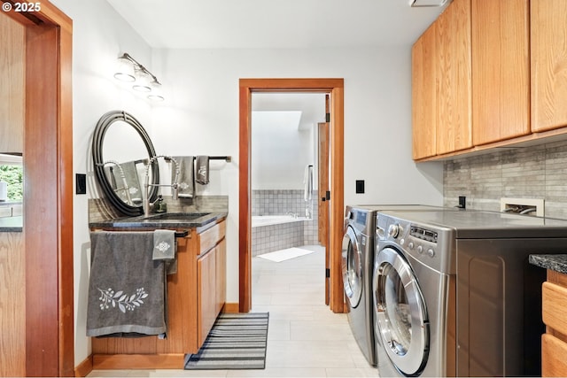 38617 SE Nichols Hill Rd, Washougal, WA 98671 - washroom featuring cabinet space, washer and clothes dryer, and light tile patterned flooring