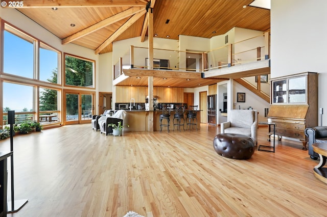 38617 SE Nichols Hill Rd, Washougal, WA 98671 - living room featuring high vaulted ceiling, a wood ceiling with exposed beams, and wood finished floors