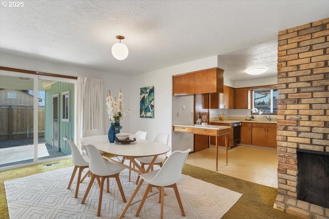 861 Dietz Ave NE, Keizer, OR 97303 - carpeted dining space featuring a textured ceiling and a brick fireplace