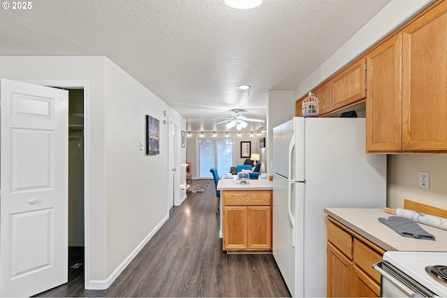 kitchen with dark wood-type flooring, ceiling fan, white appliances, and a textured ceiling