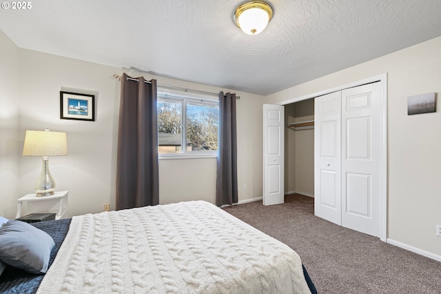 bedroom featuring dark colored carpet, a textured ceiling, and a closet