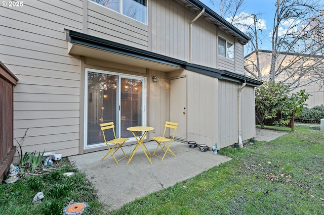 rear view of house featuring a yard and a patio area