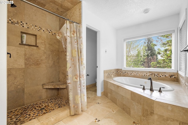 full bath featuring toilet, a bath, a textured ceiling, tile patterned flooring, and tiled shower
