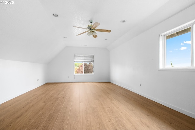 bonus room featuring light wood finished floors, a ceiling fan, baseboards, lofted ceiling, and recessed lighting