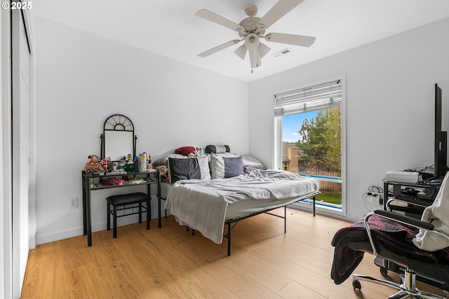 bedroom with light wood-type flooring, visible vents, access to outside, and ceiling fan