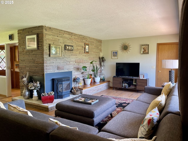 54824 Robinson Rd, Coquille, OR 97423 - living room with a textured ceiling, wood finished floors, and a wood stove