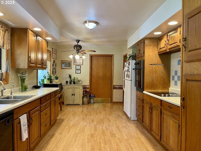 54824 Robinson Rd, Coquille, OR 97423 - kitchen with black appliances, brown cabinets, a sink, light wood-type flooring, and recessed lighting