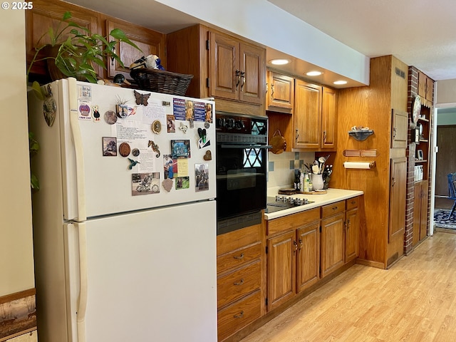54824 Robinson Rd, Coquille, OR 97423 - kitchen featuring black appliances, brown cabinets, and light wood-style flooring