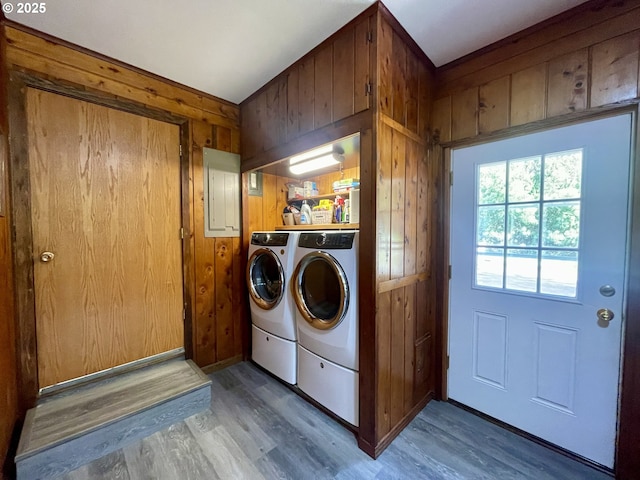54824 Robinson Rd, Coquille, OR 97423 - laundry room with washing machine and clothes dryer, electric panel, wood finished floors, and wood walls