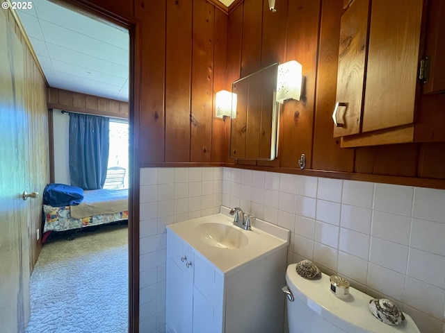 54824 Robinson Rd, Coquille, OR 97423 - bathroom with vanity, tile walls, ensuite bathroom, toilet, and tasteful backsplash