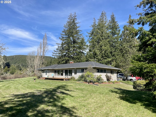 54824 Robinson Rd, Coquille, OR 97423 - single story home featuring a front yard, a wooden deck, and a chimney