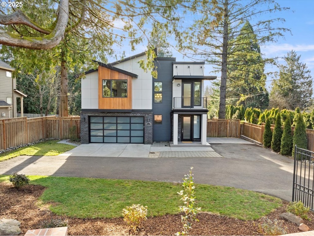 modern home featuring a balcony and a garage