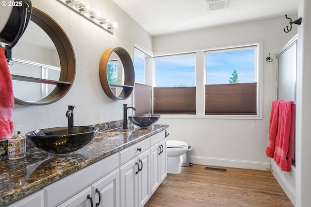 80 Sweden Cir, Silverton, OR 97381 - full bath featuring double vanity, wood finished floors, and a shower with door