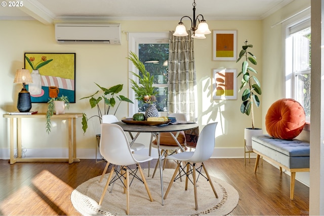 dining space with hardwood / wood-style flooring, ornamental molding, and an AC wall unit