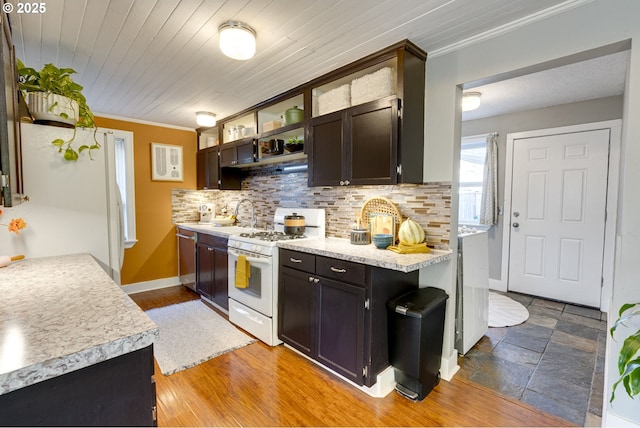 kitchen with crown molding, wood ceiling, white appliances, dark brown cabinetry, and decorative backsplash