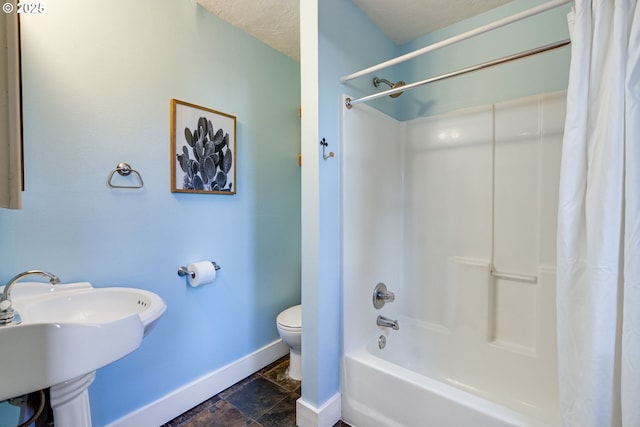 full bathroom featuring sink, shower / bath combination with curtain, and toilet