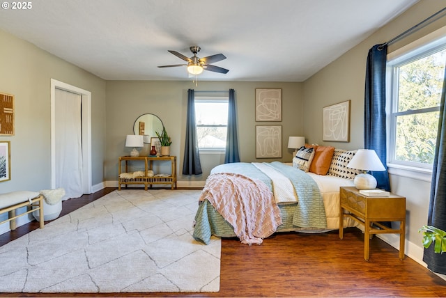 bedroom with ceiling fan and wood-type flooring