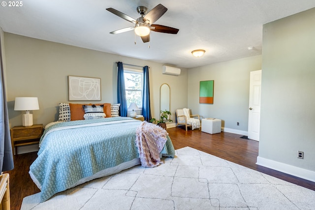 bedroom featuring ceiling fan, a wall mounted air conditioner, and hardwood / wood-style floors