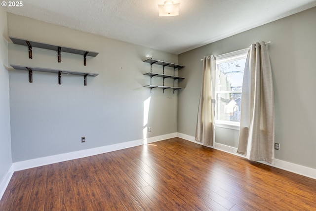 spare room with hardwood / wood-style flooring and a textured ceiling