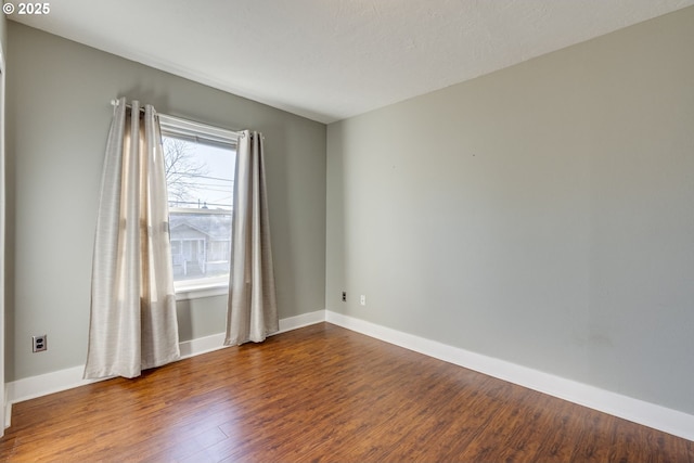 unfurnished room with hardwood / wood-style floors