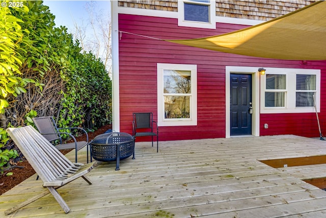 wooden deck with a fire pit