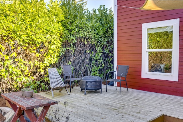 wooden deck with an outdoor fire pit