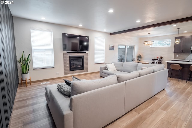 living room with beam ceiling