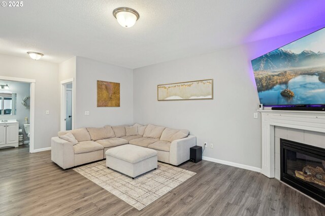 12711 NE 49th Way, Vancouver, WA 98682 - living area featuring light wood-style flooring, a tiled fireplace, recessed lighting, and washer and clothes dryer