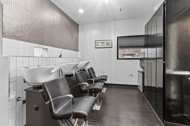 misc room featuring wood finished floors, baseboards, and a textured ceiling