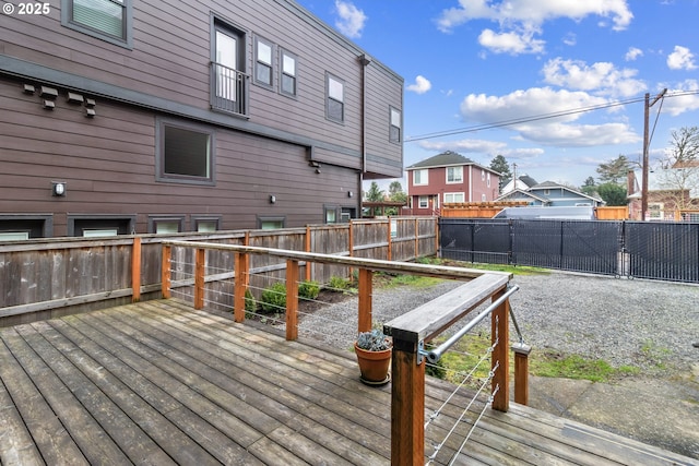 deck with a residential view and a fenced backyard