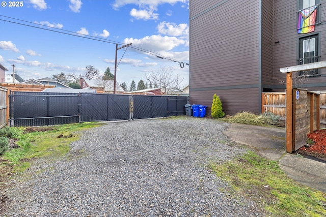 view of yard featuring fence and a gate