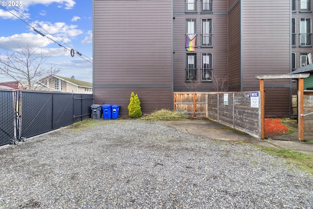 view of home's exterior with fence and driveway