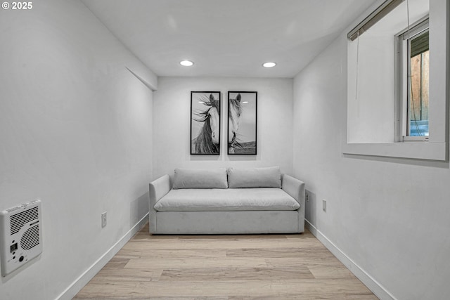 sitting room with recessed lighting, light wood-style flooring, heating unit, and baseboards
